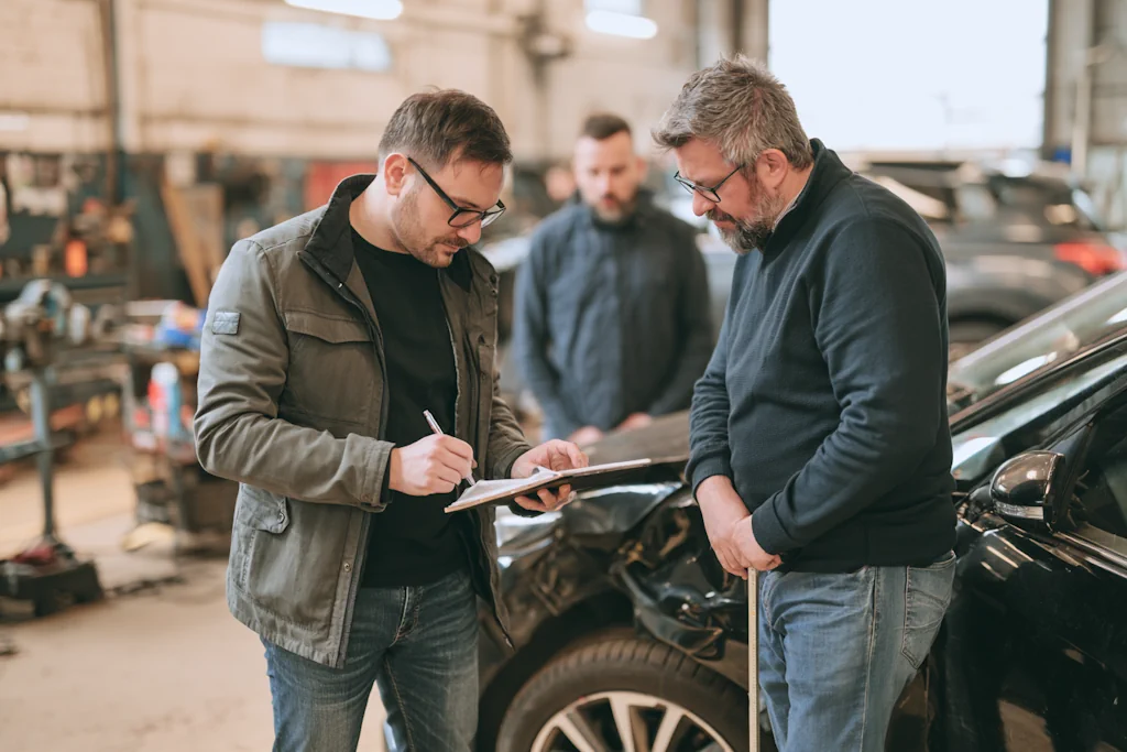 Чоловіки рахують вартість ремонту автомобіля після ДТП